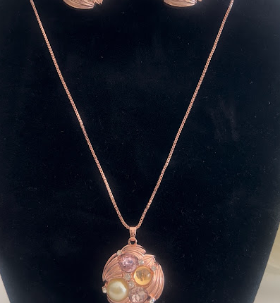 Pink necklace and earrings set with cream pebbles and gems